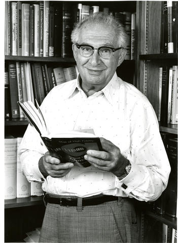 Jacob Rabinow holding a book