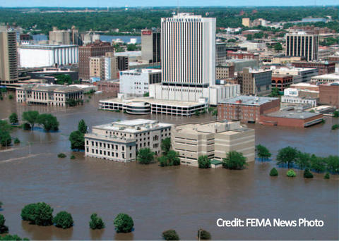 Buildings, including high rises, with water flooding the area.