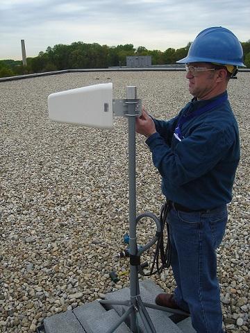 Alan Band working to install Yagi antenna  on roof of AML Bldg.