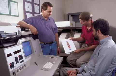 From 1998, of ACMD staff members Don Porter (left) and Mike Donahue (center) discussing micromagnetic modeling with NIST physicist Bob McMichael.
