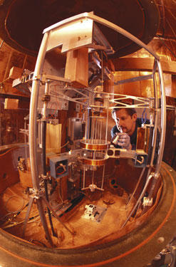 Physicist Richard Steiner adjusts the electronic kilogram, an experimental apparatus for defining mass in terms of the basic properties of nature.