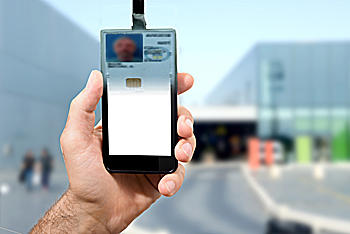 man holding cell phone and badge