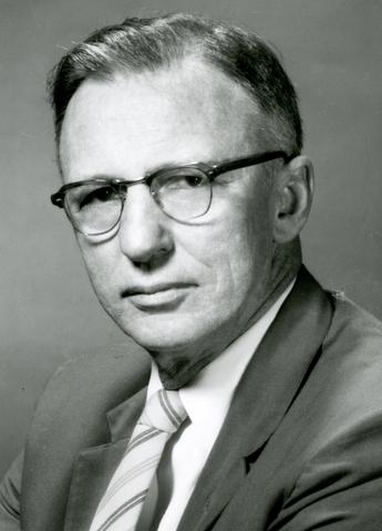 photograph portrait of a middle-aged, bespectacled man