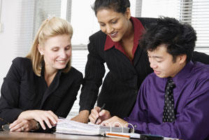 \A group of people looking over a document