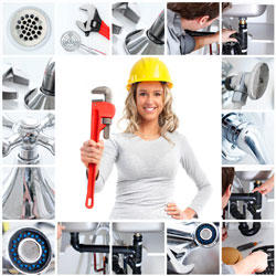 A woman wearing a hard hat and holding a wrench