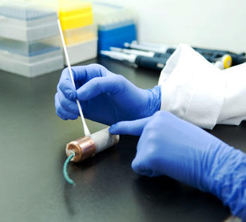 technician collecting biological material from pipe bom