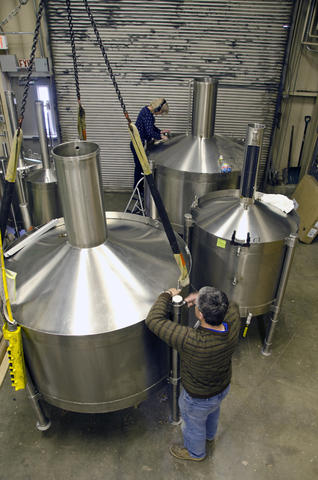 Two customers prepare their cans for calibration in PML's Fluid Metrology facility.