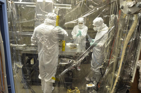 Scientists prepare to store the EUV radiometer after its extraction from the vacuum chamber.