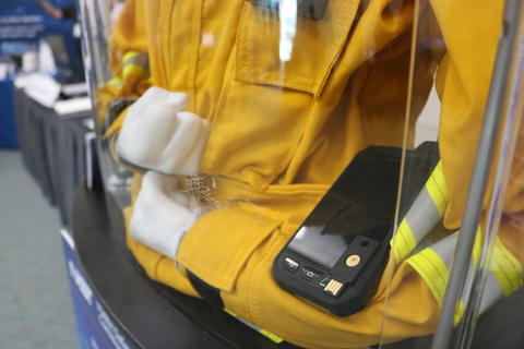 Photo of a mannequin wearing a yellow jacket and wearable technology