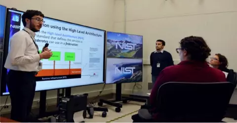 NIST researches explain Testbed operations to visitors