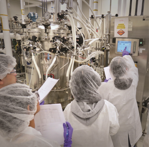 People in clean suits in a bio lab