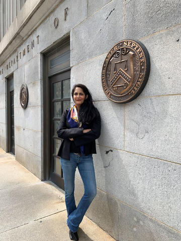 Photograph of Sarayu Srinivasan leaning against a wall