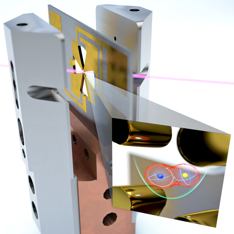 Computer-generated image showing a cross-shaped gold metal cutout on a red mount in between two metal posts, with an inset magnifying the cutout to show blue and yellow balls at the center.