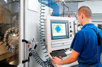 Man standing at a computer 