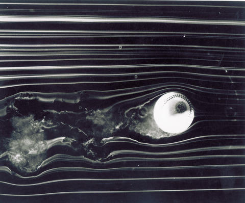 Photograph shows airflow past spinning ball in a wind tunnel.