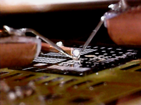 Custom-built wafer level probes in position to perform EDMR measurements on fully processed transistors. 