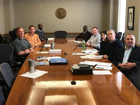 group photo of KUMC IS team members sitting around conference room table