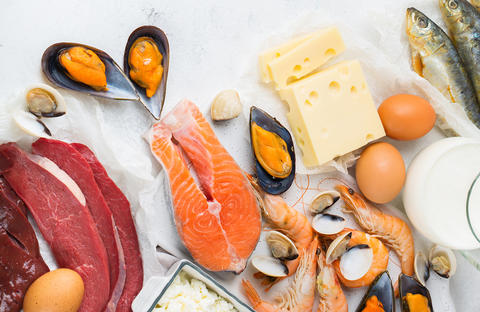 Photograph showing assorted foodstuffs that include eggs, red meat, fish, shellfish, shrimp, cheese, and milk.