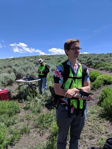 PSCR in Gypsum, Nguyen and Hamel Two men in high-visibility vests (Nguyen and Hamel) stand outside preparing electronic devices for taking measurements.