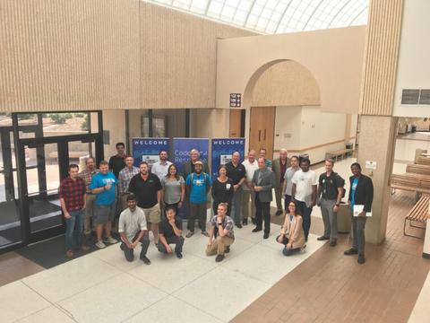 This image shows a group of people standing in front of a "code response" sign.