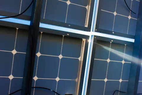 Sunlight shines through solar panel backsheet.
