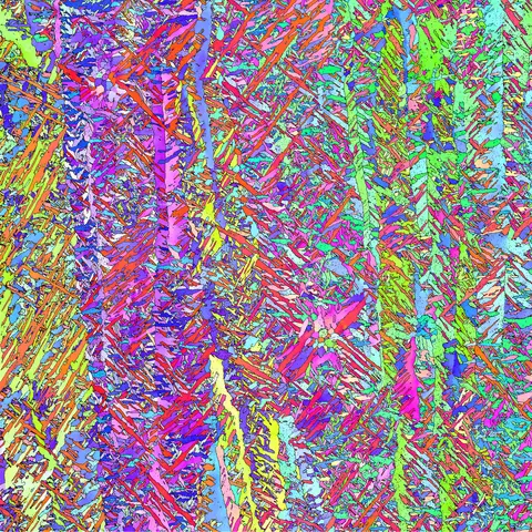 Colorized micrograph shows vertical bands and dots in purple, blue and green.