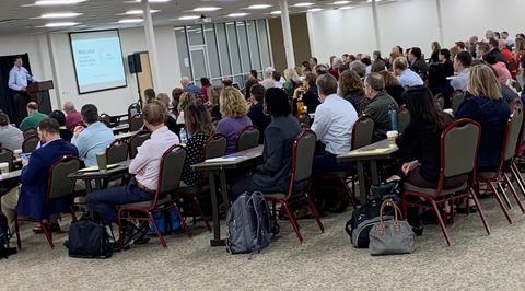 Room full of attendees at the plenary session