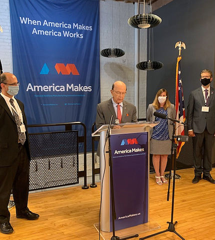 Commerce Funds Manufacturing USA Pandemic Response Projects A man stands at a podium labeled