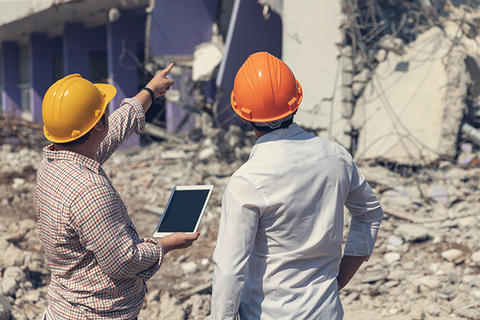 Engineer architect and worker operation control demolish old building.