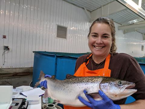 woman holding a North American Atlantic salmon