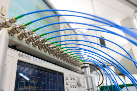 An image of radio frequency indoor localization and mapping hardware with a generator and antenna lines.