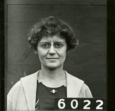 woman wearing glasses and a blouse and sweater