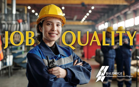 Job Quality text showing smiling female worker of modern industrial factory in workwear and protective helmet standing in large workshop.