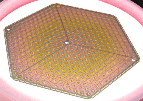 Six-sided metallic plate has rows of pinkish sensors.