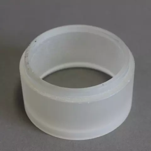 A short whitish cylinder of glass on a gray surface