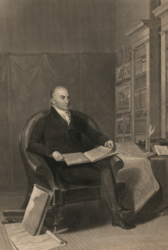Sepia photo of John Quincy Adams sitting in a chair by bookshelf