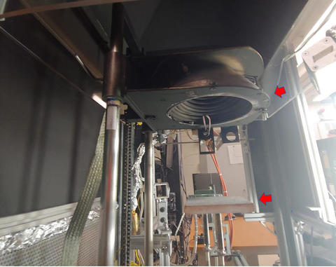 A close-up of the cone-shaped electric heater (see the top arrow) and sample platform (see the bottom arrow).
