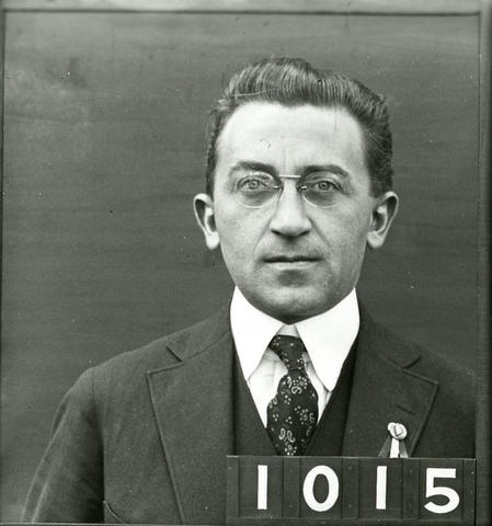 black and white headshot of a man in a 3-piece suit and tie. The numbers 1015 are in the lower right corner.