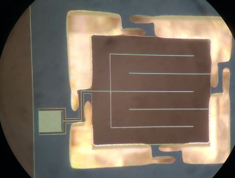 Prototype superconducting sensor is a square chip with lines running through it.