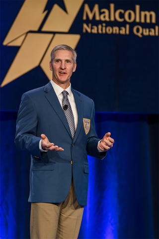 Matt Fleming, President and CEO, MidwayUSA 2021 Baldrige Award Recipient presenting at the 33rd Quest for Excellence in his Baldrige jacket.