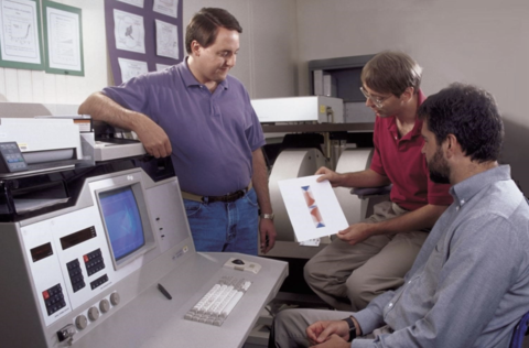 Donald Porter (left) and Michael Donahue (center) discuss a micromagnetic simulation with NIST physicist Robert McMichael.  Photo credit: NIST 