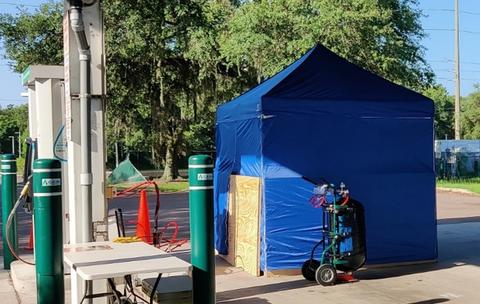 Typical setup for testing of CNG dispensers. The dispensed CNG is stored in the tank which is then weighed on a scale inside a tent to minimize the influence of wind.