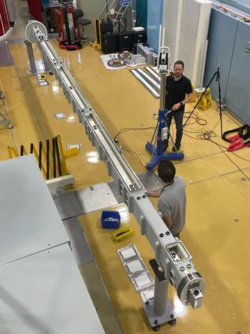 NCNR Personnel installing a guide rail 