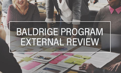 Baldrige Program External Review text showing a group of people talking.