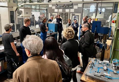 Germany mission participants meet with apprentices and their trainer at a small manufacturer in Duren.