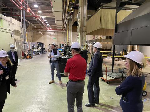 Individuals in hard hats in a laboratory