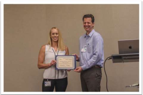 Beth Ordeman, Chair of OSAC's Human Forensic Biology Subcommittee accepting the Outstanding Group Award from JP Jones, OSAC Program Manager