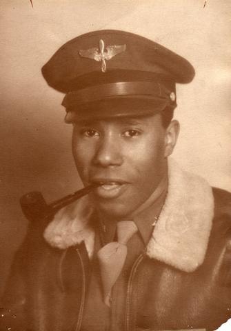 Moe Thomas Jr. poses in his airman uniform with a pipe in his mouth in a historical photo.