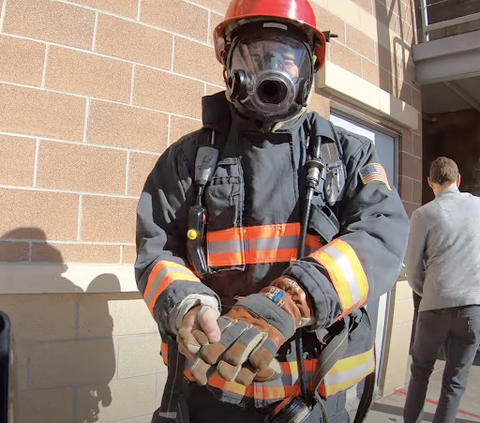 Firefighters wearing the Extreme Reality helmet with the haptic interface