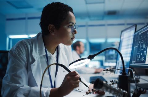 A woman tests electronic equipment